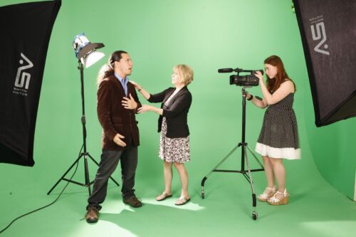 Multimedia Design Degree Ranked Among Nation’s Top 15 Visual Arts Chair Cece Wheeler is flanked by students in the College's green screen studio