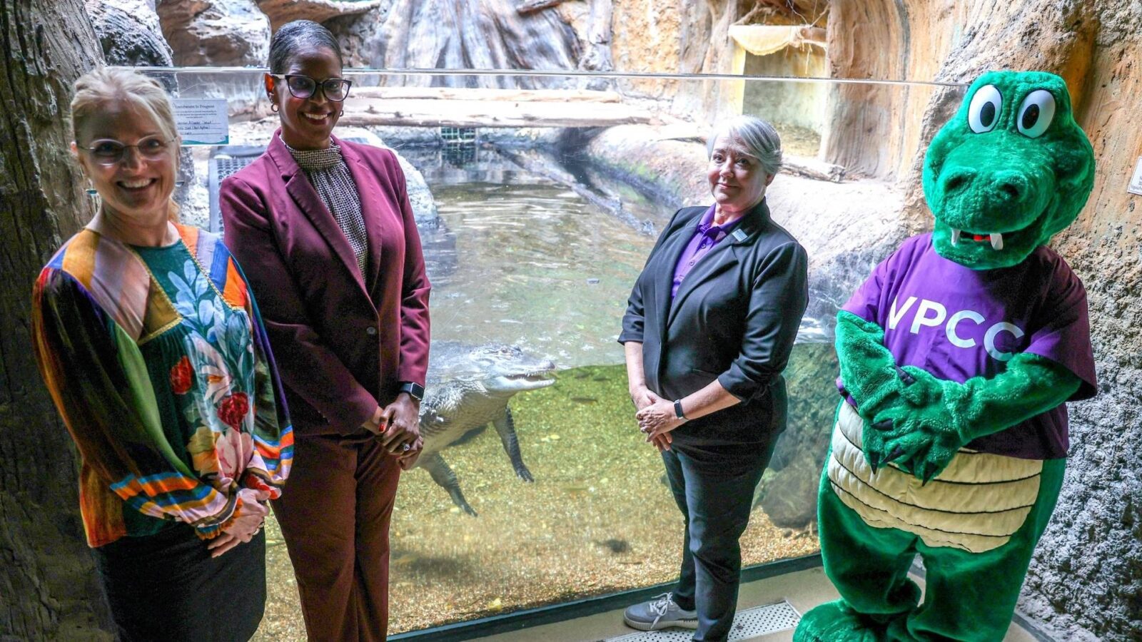 VPCC President Dr. Towuanna Porter Brannon (second from left) and VLM Executive Director Rebecca Kleinhample (left) announced a partnership to adopt Newt (middle). Also on hand were VPCC Creative Communication Services manager and alum Michelle Shonk (second from right), who spearheaded the idea, and Gillie the Gator, VPCC’s mascot.