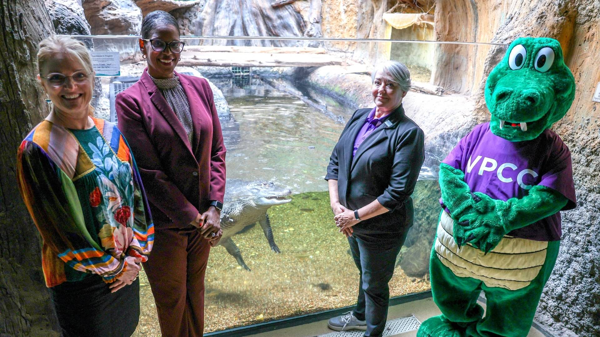 VPCC President Dr. Towuanna Porter Brannon (second from left) and VLM Executive Director Rebecca Kleinhample (left) announced a partnership to adopt Newt (middle). Also on hand were VPCC Creative Communication Services manager and alum Michelle Shonk (second from right), who spearheaded the idea, and Gillie the Gator, VPCC’s mascot.