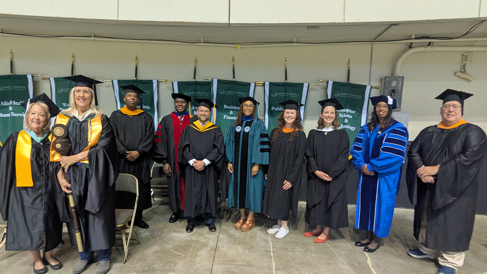 Featured image for the page. Photo of professors during a graduation ceremony.