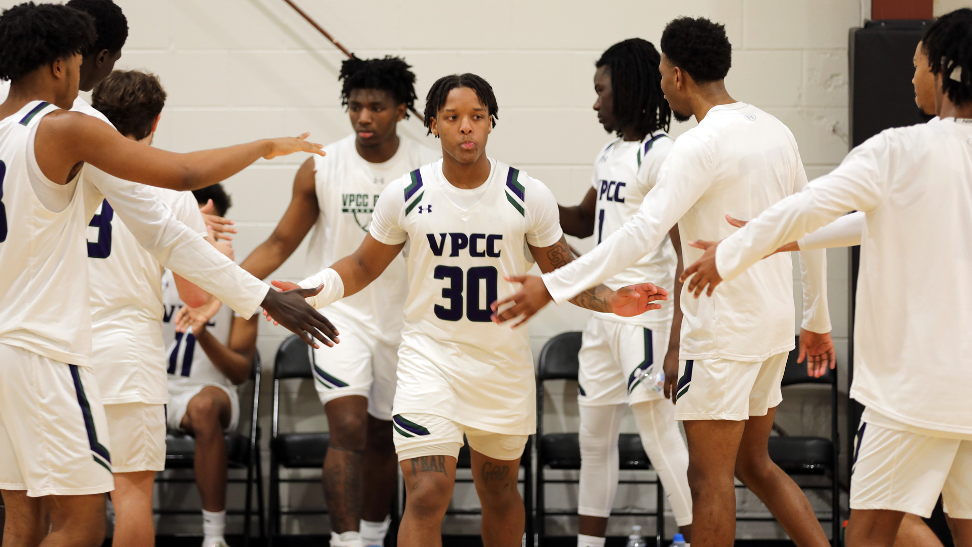 Jakobe Reed (30) is introduced onto the court last season at SafeHaven. 