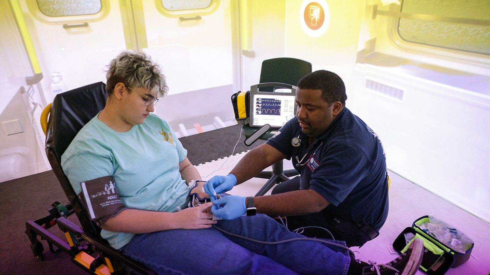 Theater student Jay Mims (left) and EMT student Matthew Rock provided each other with valuable hands-on learning on a recent exercise.