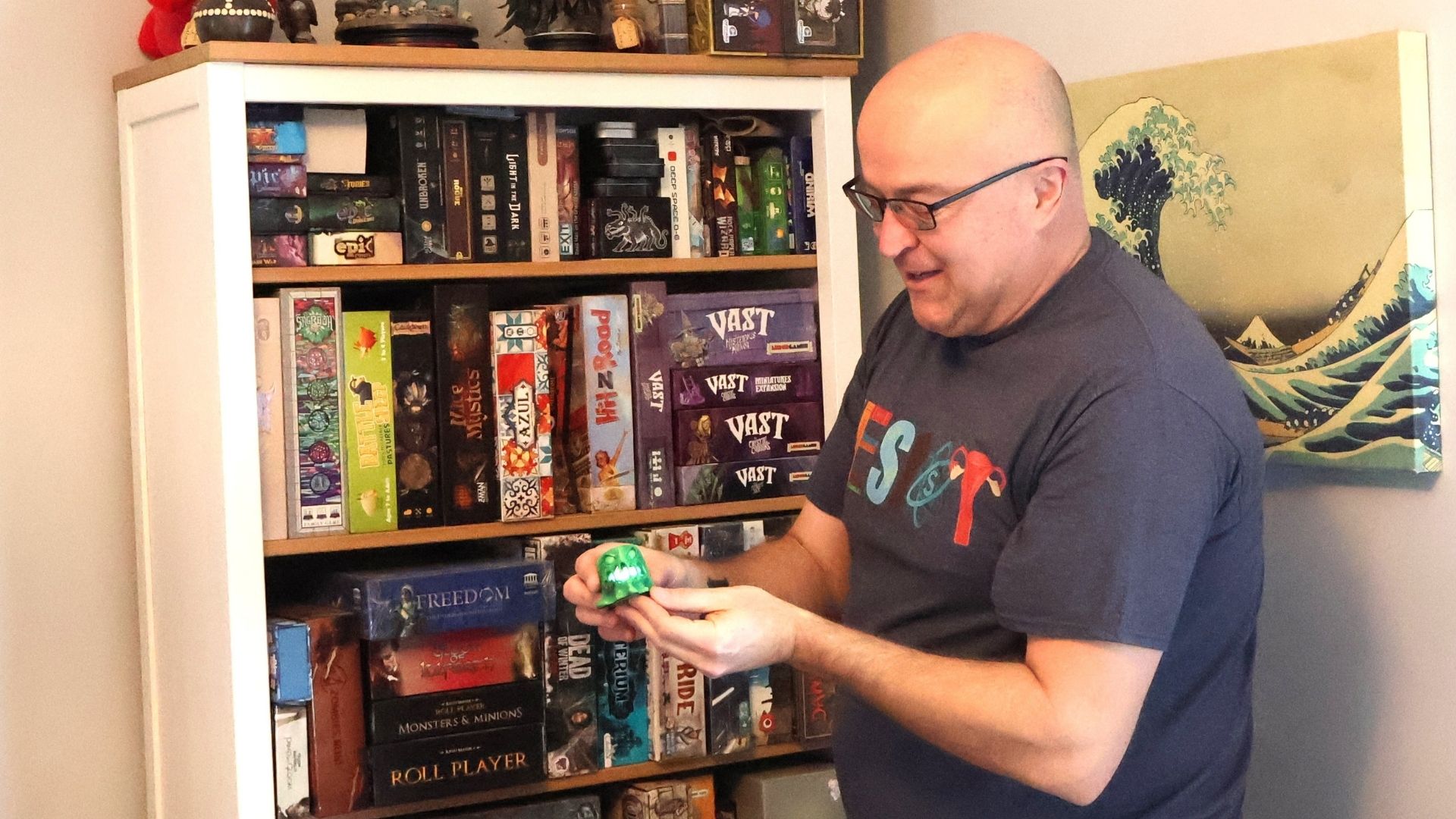 Jason Moulenbelt holds a 3-D printed and hand-painted Gelatinous Cube by  CAPMastor Studios. It is used in "Dungeons and Dragons."