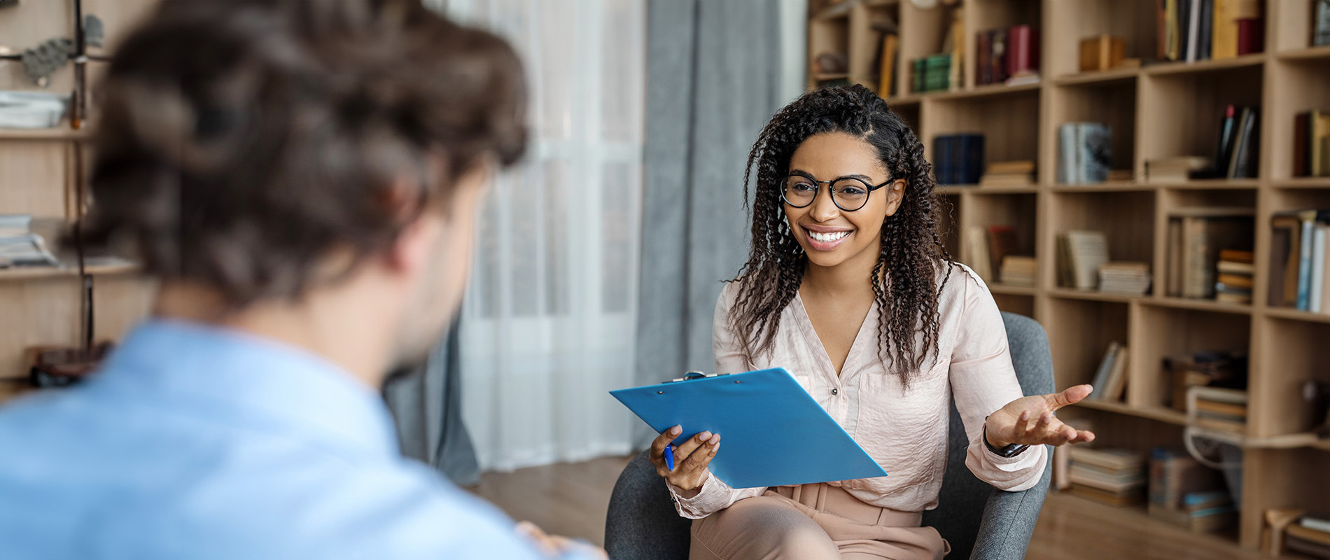 A female life coach in an office talking to a person