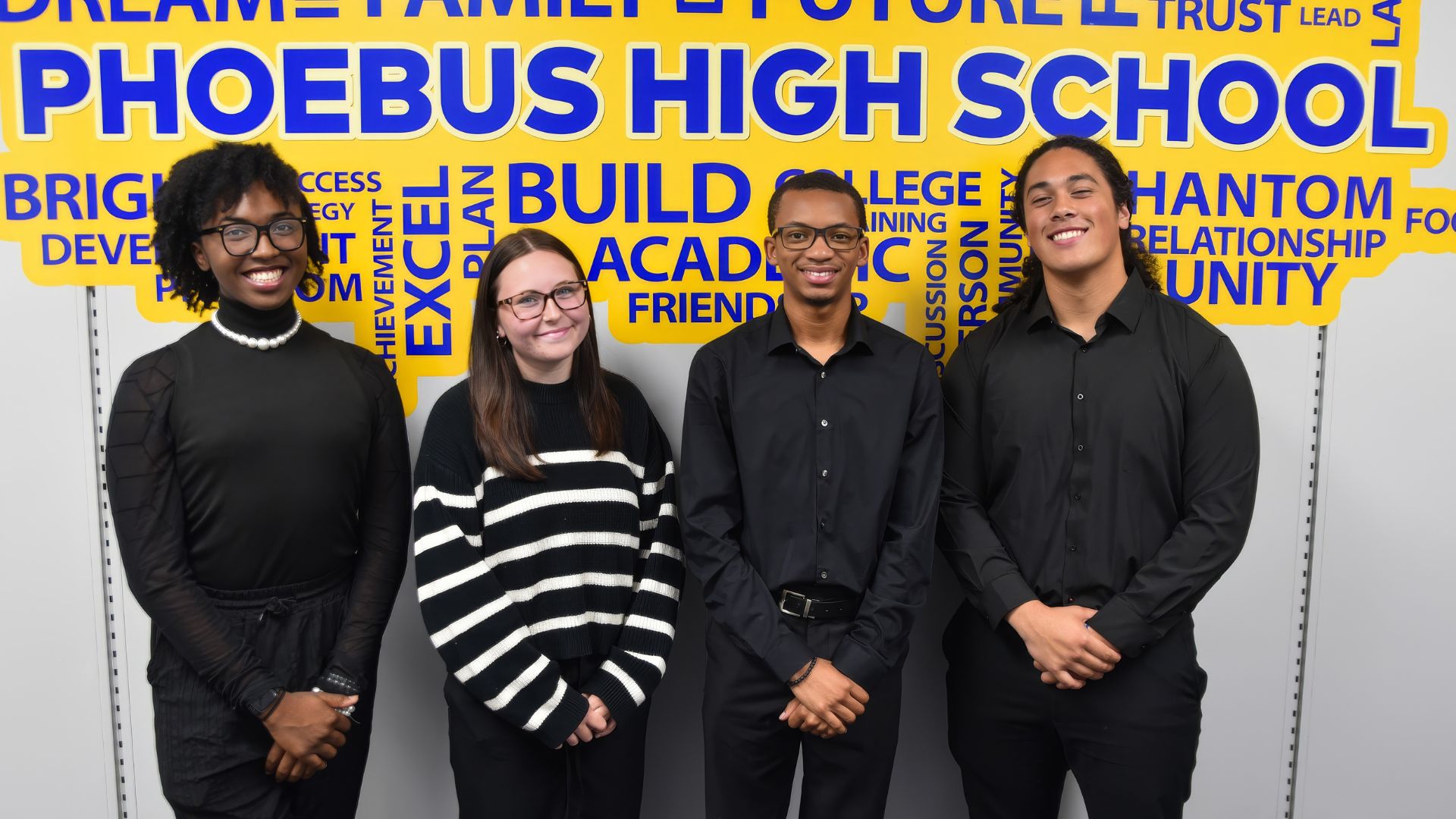 Multiethnic group of four people standing in front of a colorful wall