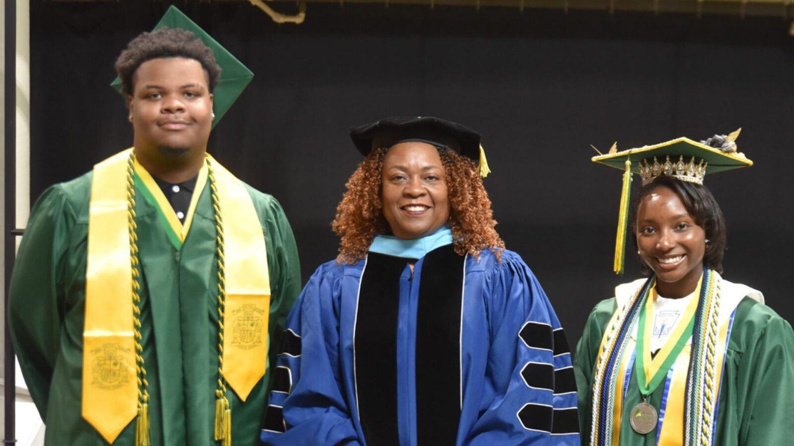 Kameron Mann (left) and Kaela Jordan (right) were all smiles at their high school graduation in early June. With them is executive principal Dr. Tanya Howard.