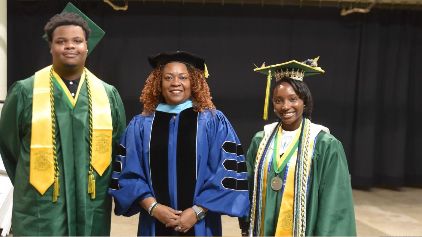Kameron Mann (left) and Kaela Jordan (right) were all smiles at their high school graduation in early June. With them is executive principal Dr. Tanya Howard.
