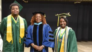 Kameron Mann (left) and Kaela Jordan (right) were all smiles at their high school graduation in early June. With them is executive principal Dr. Tanya Howard.