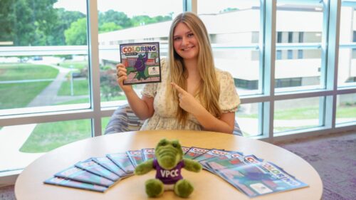 Student Cami Dunlap shows off her VPCC coloring book.