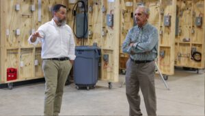 Todd Estes (left), the vice president of Workforce Development & Innovation at VPCC, gives Dr. Larry Dotolo a tour of the College’s Newport News Trades Center.