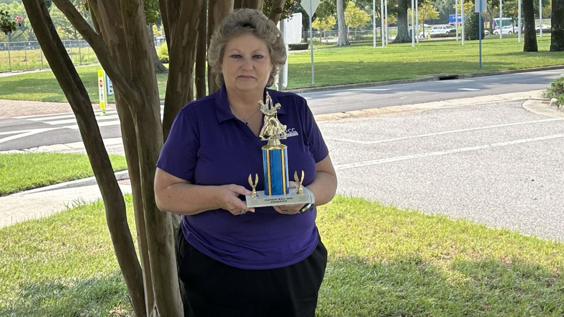 Pam Roberts, VPCC's ballroom dance team adviser, shows off the team's latest hardware.