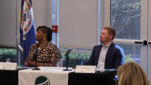 Andrea Washington (left) with Bank of America and Larry Pullen (right) with United Data Technologies listen to fellow panelist A.J. Cupp (not pictured) with the Newport News Police Department make a point during the seminar.