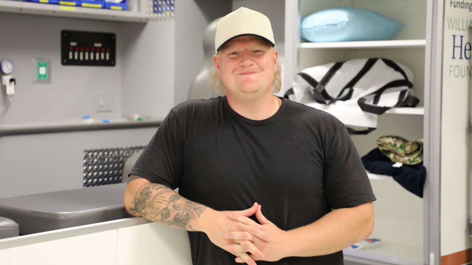 Man wearing a black shirt and a hat